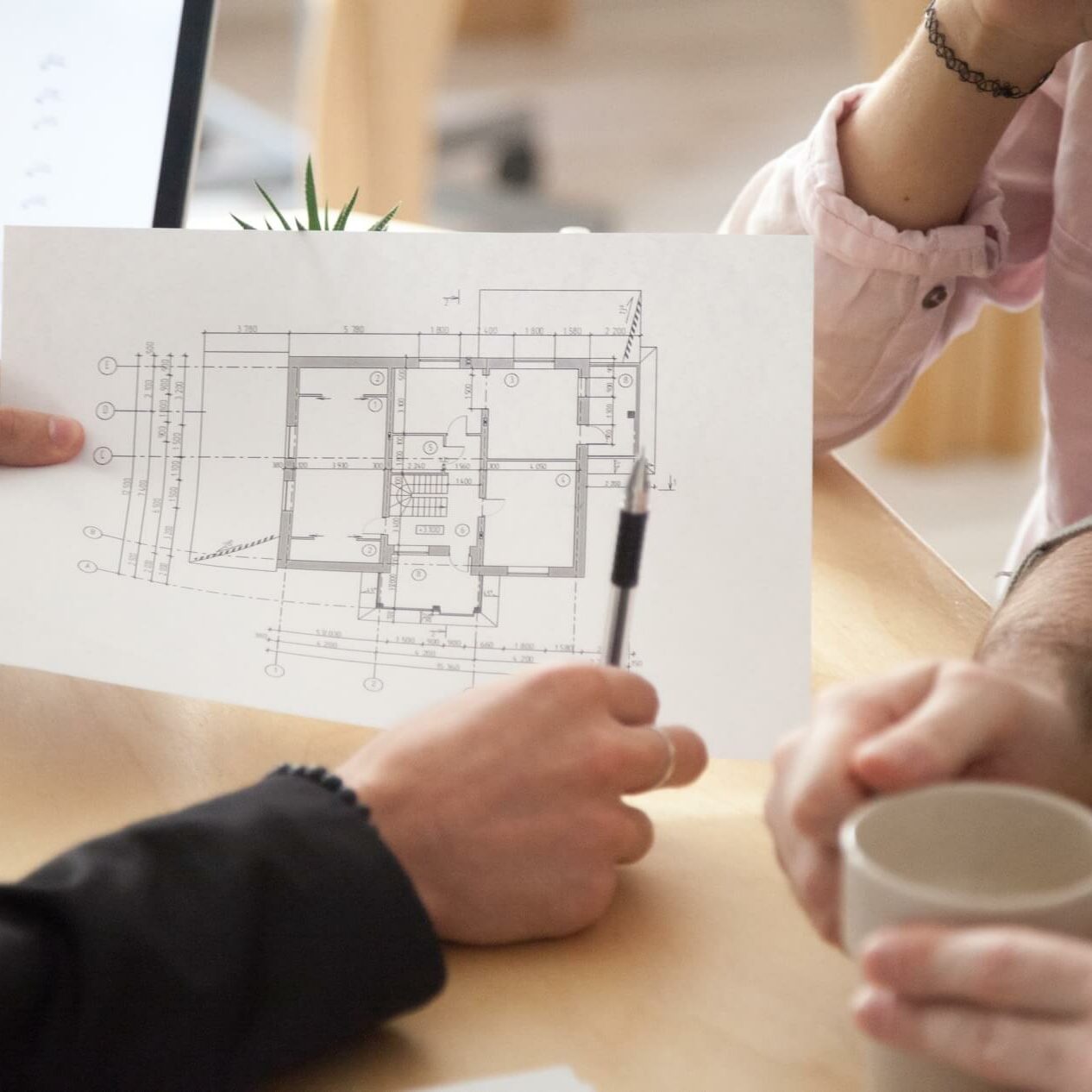 Architect showing new apartment plan to couple at meeting
